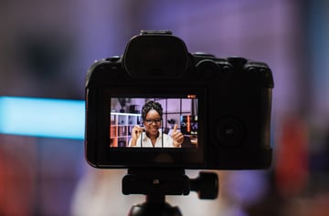 Focus on camera screen with experienced smart female african american office manager