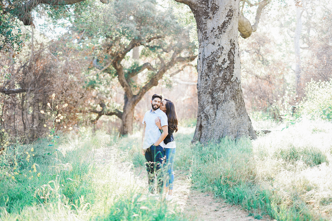 Engagement photo of couple in the woods
